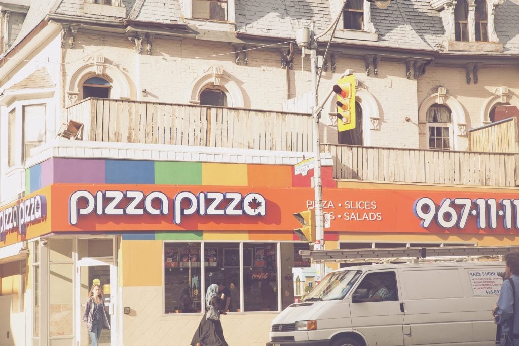 pizza pizza with rainbow sign in church and Wellesley, toronto